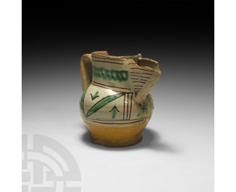 14th-15th century AD. An earthenware jug or pitcher with a squat, bulbous body, broad neck, V-section spout, strap handle and