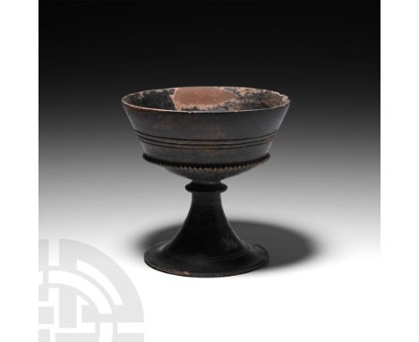 7th-6th century BC. A Rasmussen’s type 2d Bucchero pottery chalice, composed of a carinated bowl, collared stem and splayed f