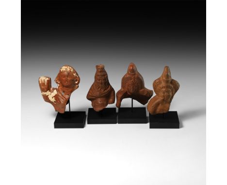 1st-2nd century AD. A group of votive terracotta figures comprising: the bust of the god Serapis, depicted bearded as Zeus an