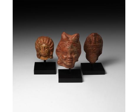 2nd century AD. A group of votive terracotta figure heads comprising: two female heads with Graeco-Egyptian coiffures, one wi