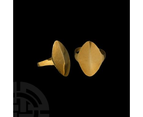 15th-12th century BC. A sheet-gold ring with narrow hoop and pointed oval bezel, the bezel curved to provide a shield-like ri
