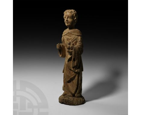 15th-16th century AD. An English carved oak figurine of a youthful monk with flowing hair wearing a floor-length tunic, scapu