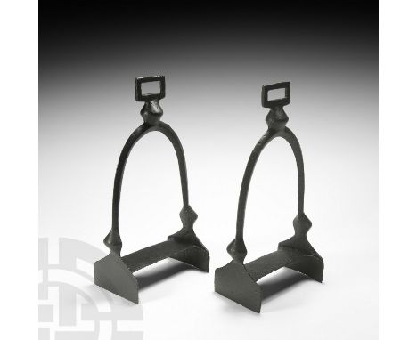 10th century AD. A matched pair of iron stirrups, each a long lozenge-section arch with rhomboid-shaped finial and side bosse