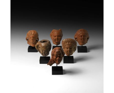 1st century BC-2nd century AD. A group of votive terracotta figure heads comprising: three female heads of orantes with circu