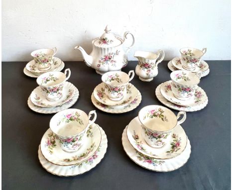A Royal Albert bone china Moss Rose pattern tea service - comprising a teapot (tiny chip to spout); a milk jug; three graduat