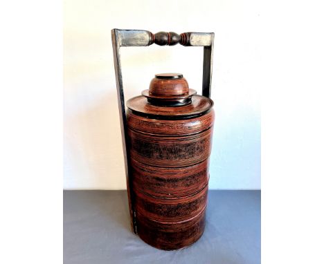 A Burmese lacquered seven section tiffin or food container - first half 20th century, the red and black lacquered exterior de
