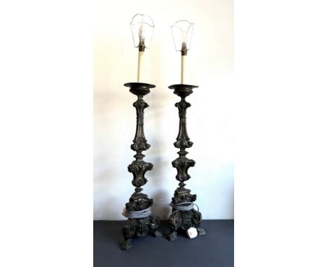 A pair of Baroque style brass candlestick lamps - early 20th century in the 17th century style, converted to lamps, the trifo