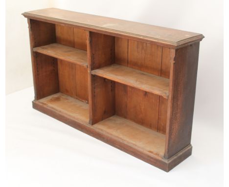 A late-Victorian oak low open bookcase - the moulded top over a two-sided bookcase section, each side with a single adjustabl