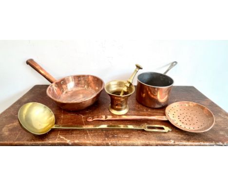 A small group of antique copper and brass kitchen implements - including a trench art brass pestle and mortar; a German coppe