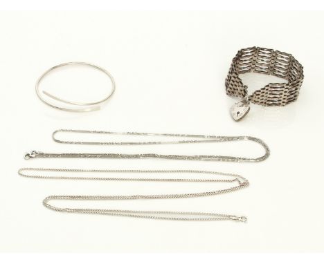 Four pieces of silver jewellery - comprising a gatelink bracelet with heart padlock clasp; a modernist crossover bangle; and 