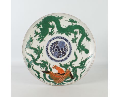 A Japanese Arita porcelain dragon and phoenix saucer dish - made for the Chinese market, painted with a green enamelled long 