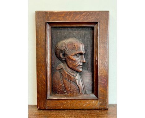 A carved oak portrait panel, probably c.1900 - northern European, depicting a bust length portrait of a gentleman in profile,