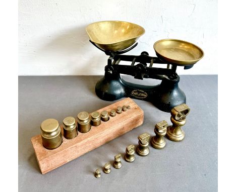 A set of cast iron and brass kitchen scales by Scotts of Stow - with a set of seven Imperial brass weights (1lb to &frac14;oz