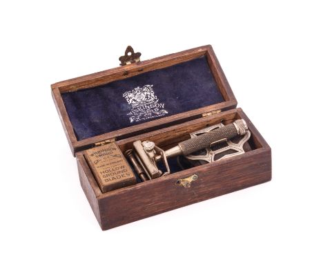 An oak cased Wilkinson Sword nickel plated razor - early 20th century, in good condition, complete with strop and box of blad