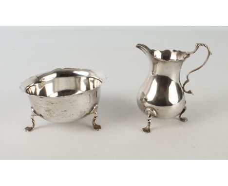 A Victorian silver baluster cream jug and matching sugar basin - Stokes &amp; Ireland Ltd., Birmingham 1887, with cut card ri