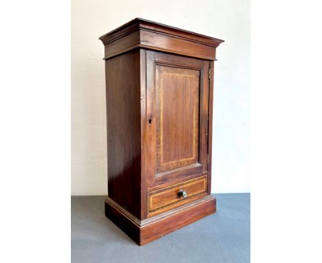 An Edwardian small mahogany and satinwood banded tabletop cabinet - the flared ogee cornice over a single panelled door enclo