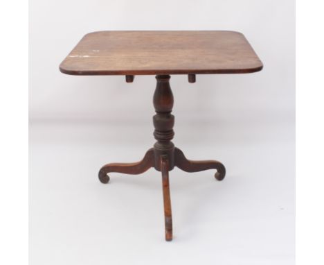 A late-George III mahogany tilt-top tripod supper table - the rectangular top raised on a turned baluster column to three swe