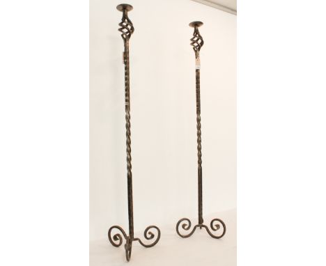 A pair of wrought iron candle stands - modern, painted gunmetal, with part barleytwist and pierced spiral columns, on scrolle