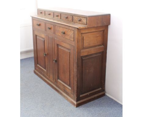 A mid-19th century mahogany, beech and pine country house style housekeeper's cabinet - the top with a recessed bank of five 