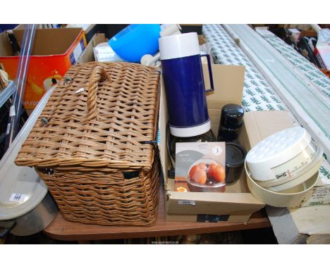 A wicker Fishing basket, thermos, scales and an egg cooker.