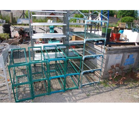 A small greenhouse frame and four shelf units.