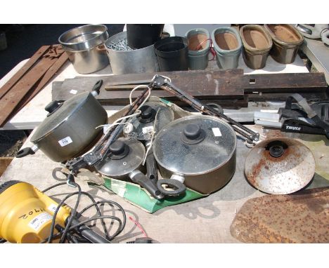 An angle poise lamp and four saucepans.