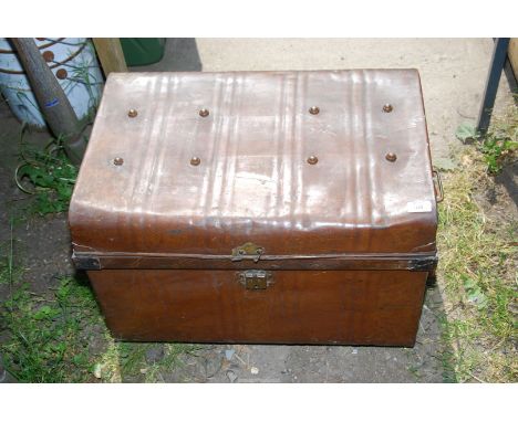 A metal trunk and child's sewing machine.