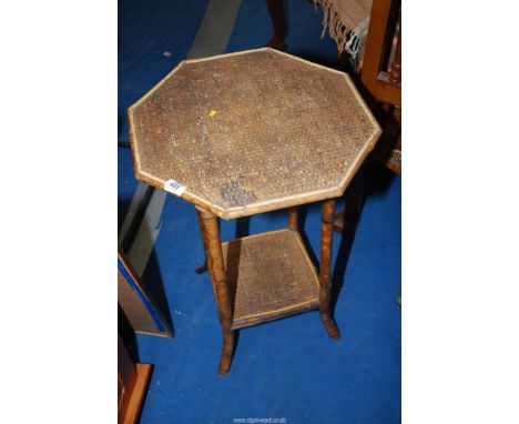 A small bamboo table with lower shelf.