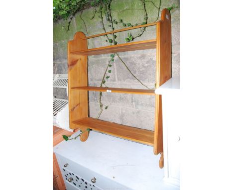 A pine wall shelf, 32" wide x 42" high x 8 3/4" deep.