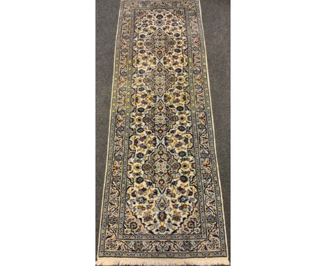 A fine Persian, hand-made Kashan runner carpet, woven in shades of blue and red on a pale cream ground, 289cm x 102cm. 