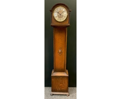 An early 20th century oak longcase clock of small proportions, arched case, the silvered dial with Arabic numerals, twin wind