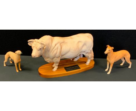 A Beswick Connoisseur model of a Charolais Bull, on wood base, 20.5cms high, ;  a Beswick Greyhound, CH Jovial Roger;  anothe