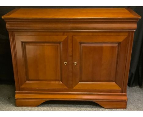 A contemporary Ernest Menard mahogany sideboard, rounded rectangular top above a pair of long drawers and a pair of cupboard 