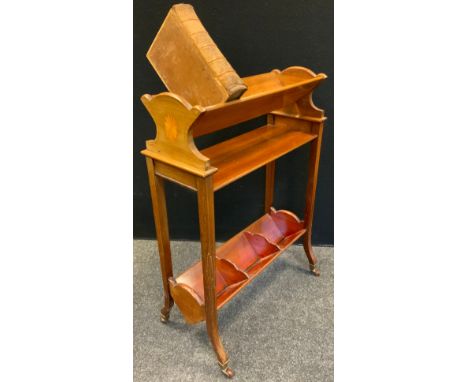 An Edwardian inlaid mahogany book trough, triangular trough top and under tier, slayed legs, castor terminals, 76cm high, 55c