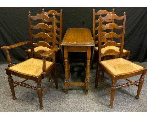 A set of four 19th century style oak ladder back dining chairs (three chairs plus one carver), and an oak drop leaf table. 