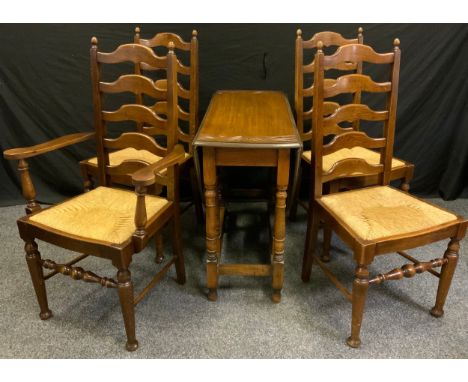 A set of four 19th century style oak ladder back dining chairs (three chairs plus one carver), and an oak drop leaf table. 