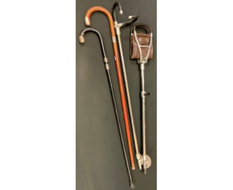 A silver mounted walking stick;  a shooting stick;  another;  etc 