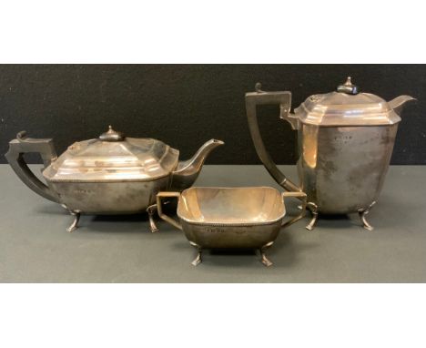 A silver three piece tea set, comprising teapot, hot water jug, and sucrier, Birmingham  1935 and 1933, 53oz gross. 