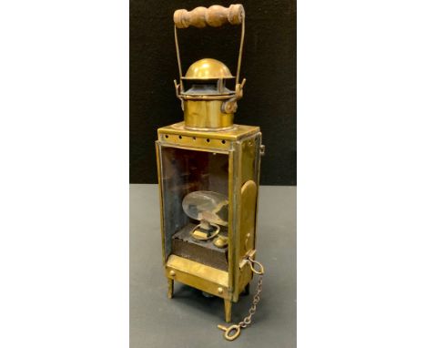 An Edwardian Bulpitt &amp; Sons maritime signal lamp, rectangular brass case, glazed front, sliding side cover, iron reservoi