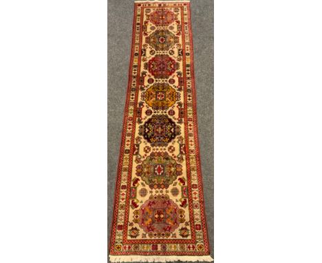 A fine, hand-made Behbahan runner carpet, 305cm x 77cm. 