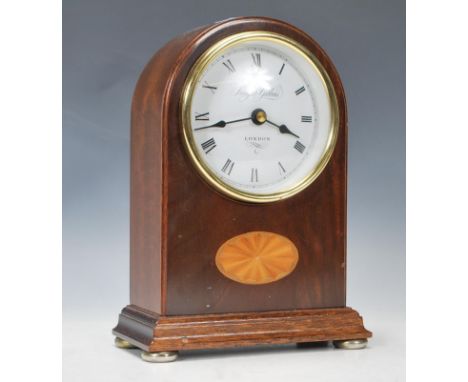 A 20th Century contemporary mahogany inlaid cased mantel clock by Knight &amp; Gibbons, the clock of Spire form with a circul