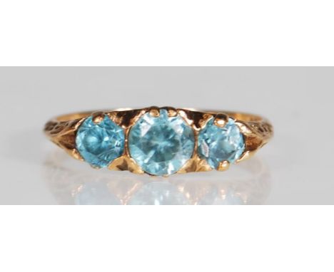 A hallmarked 9ct gold and blue zircon three stone ring. The ring set with three graduating round mixed cut blue zircon within