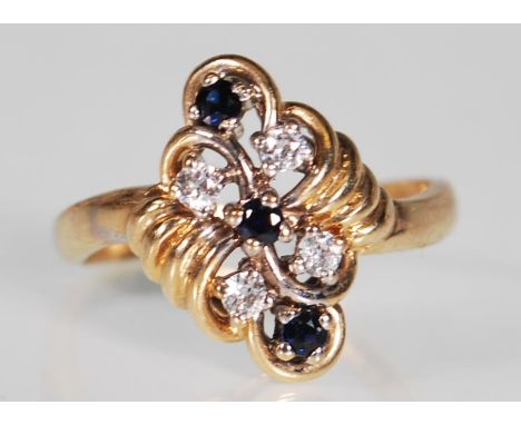 A hallmarked 9ct gold sapphire and white stone dress ring. The ring having a plaited foliate style cluster set with sapphires