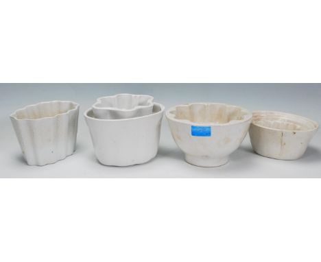 A group of five ceramic jelly moulds dating from the 19th Century with four having decrtive patterns and one form a lion. Big