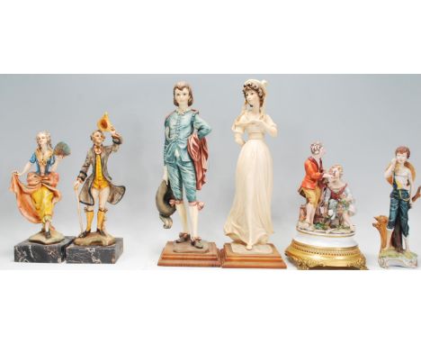 A group of Italian ceramic figurines to include a Capodimonte figurine of a boy leaning on a tree trunk, a Capodimonte figure