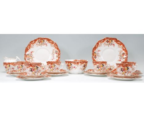 An early 20th century Wellington China part tea service of reeded form having transfer printed floral decoration with hand co