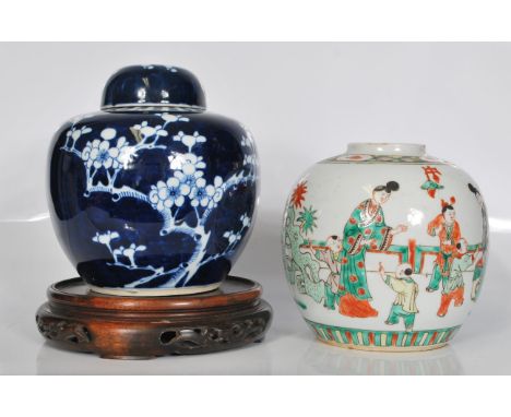 A 19th Century Chinese ginger jar in the prunus pattern of bulbous form complete with lid and carved wooden stand together wi
