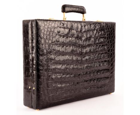 A good quality vintage black crocodile leather executive attaché briefcase with gold coloured hardware, suede interior and co