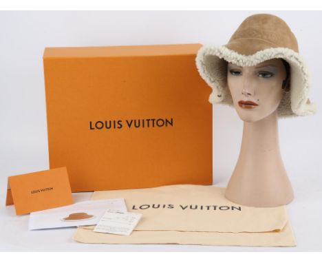 LOUIS VUITTON A unisex Shearlingham 100% wool shearling hat in camel brown with monogram canvas detail size S/M. Boxed with d
