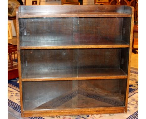 Oak four shelf book case with sliding doors